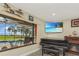 Living room featuring a pool view, a TV, and a piano at 955 Mansfield Rd, Tavares, FL 32778