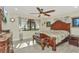 Spacious main bedroom featuring a large bed, ceiling fan, and sunny window at 955 Mansfield Rd, Tavares, FL 32778