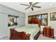Bright main bedroom featuring a bed, ceiling fan, and built-in cabinets at 955 Mansfield Rd, Tavares, FL 32778
