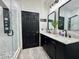 Modern bathroom featuring double sinks, a marble countertop, and a glass-enclosed shower with a rainfall showerhead at 1025 Belvoir Dr, Kissimmee, FL 34744