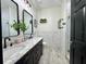 Modern bathroom features a double sink vanity with marble countertops and elegant fixtures at 1025 Belvoir Dr, Kissimmee, FL 34744