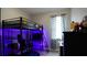 A gaming themed bedroom with a loft bed, desk, and TV; illuminated with LED lighting at 1025 Belvoir Dr, Kissimmee, FL 34744