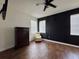 Bedroom featuring a dresser, comfortable chair, and a stylish black accent wall at 1025 Belvoir Dr, Kissimmee, FL 34744