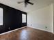 Bedroom with stylish black accent wall and ceiling fan at 1025 Belvoir Dr, Kissimmee, FL 34744
