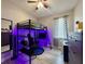 A gaming bedroom featuring a loft bed, desk, and color changing LED lights for a fun atmosphere at 1025 Belvoir Dr, Kissimmee, FL 34744