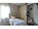 A well-decorated bedroom featuring a barn-style door, soft colors, and themed decor at 1025 Belvoir Dr, Kissimmee, FL 34744