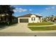Charming single-story home with a well-maintained lawn and a two-car garage, perfect for suburban living at 1025 Belvoir Dr, Kissimmee, FL 34744