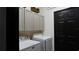 Contemporary laundry area with cabinets above a modern washer and dryer and a black door at 1025 Belvoir Dr, Kissimmee, FL 34744
