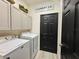 Well-organized laundry room with ample cabinet space and modern washer and dryer units at 1025 Belvoir Dr, Kissimmee, FL 34744