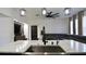 Open-concept living space with island, featuring modern lighting and a comfortable gray sectional sofa at 1025 Belvoir Dr, Kissimmee, FL 34744