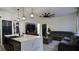 Bright living area with an island, a large television, and a gray sectional sofa at 1025 Belvoir Dr, Kissimmee, FL 34744