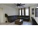 Cozy living room featuring a comfortable gray sectional sofa and natural light at 1025 Belvoir Dr, Kissimmee, FL 34744