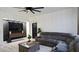 Comfortable living room features a gray sectional sofa and a decorative wall at 1025 Belvoir Dr, Kissimmee, FL 34744
