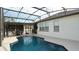 The backyard pool is screened in and lit with exterior lighting at 1025 Belvoir Dr, Kissimmee, FL 34744