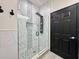 A modern glass walk-in shower with elegant stone accents, a rainfall showerhead, and sleek fixtures at 1025 Belvoir Dr, Kissimmee, FL 34744