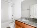 Bathroom features a combination tub and shower, granite countertop and white tile surround at 11037 Bagley Aly, Windermere, FL 34786