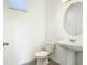 Powder room featuring modern fixtures, including a pedestal sink and oval mirror at 11037 Bagley Aly, Windermere, FL 34786