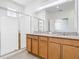 Bright bathroom featuring a double vanity, granite countertop and a glass-enclosed shower at 11037 Bagley Aly, Windermere, FL 34786