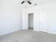 A bright bedroom features neutral carpet, a ceiling fan, and closet and bathroom access at 11037 Bagley Aly, Windermere, FL 34786