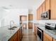 Contemporary kitchen with granite countertops, stainless steel appliances, and ample storage at 11037 Bagley Aly, Windermere, FL 34786
