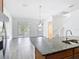Bright kitchen with granite counters and stainless steel appliances leading to the living room at 11037 Bagley Aly, Windermere, FL 34786