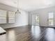 Sunlit living room with modern chandelier and access to the balcony and backyard at 11037 Bagley Aly, Windermere, FL 34786