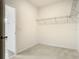 Walk-in closet offers ample storage space with wire shelving and neutral carpet flooring at 11037 Bagley Aly, Windermere, FL 34786