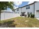 Spacious backyard featuring a patio area, lush lawn, and white fencing at 1113 Merrill St, Davenport, FL 33837