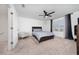 Well-lit bedroom featuring a queen-sized bed, ceiling fan, and neutral color palette at 1113 Merrill St, Davenport, FL 33837