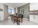 Bright dining area featuring a glass table with seating for four and sliding glass doors to the backyard at 1113 Merrill St, Davenport, FL 33837