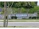 Stone entrance sign to the Madison Place community with flowering trees in background at 1113 Merrill St, Davenport, FL 33837