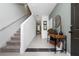 Inviting entryway with tiled floors, a console table, and a staircase at 1113 Merrill St, Davenport, FL 33837