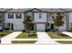 Charming townhomes featuring individual driveways, attached garages and green spaces at 1113 Merrill St, Davenport, FL 33837