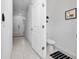 Hallway with white walls, tiled floor and view of a half bathroom at 1113 Merrill St, Davenport, FL 33837
