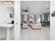 Open concept living room view from bathroom with stylish decor and natural light at 1113 Merrill St, Davenport, FL 33837