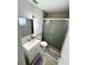 Cozy bathroom featuring a glass enclosed shower, modern fixtures, and sleek design at 1126 Orwell Ave, Orlando, FL 32809