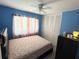Serene bedroom with pastel-blue walls, white closet doors, and good natural light at 1126 Orwell Ave, Orlando, FL 32809