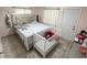 Bedroom with a large bed, light tile flooring and a crib at 1126 Orwell Ave, Orlando, FL 32809