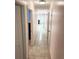 Hallway view to bedroom with neutral paint colors and tile flooring at 1126 Orwell Ave, Orlando, FL 32809