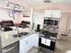 Open kitchen view with stainless steel appliances, granite countertops, and open layout to living area at 1126 Orwell Ave, Orlando, FL 32809