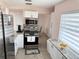 Modern kitchen featuring white cabinets, stainless steel appliances, and a granite countertop at 1126 Orwell Ave, Orlando, FL 32809