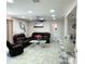 Spacious living room with leather couches, tile floors, and view to the kitchen at 1126 Orwell Ave, Orlando, FL 32809