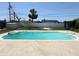 In-ground pool with sunny backyard, a concrete deck and a clear blue sky overhead at 1126 Orwell Ave, Orlando, FL 32809