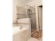 Bathroom featuring a tub with tile surround, glass enclosed shower and tile flooring at 11378 Whistling Pine Way, Orlando, FL 32832