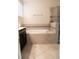 Bathroom featuring tile flooring, tub with grey mosaic accents, and a glass enclosed shower at 11378 Whistling Pine Way, Orlando, FL 32832