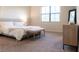 Bright bedroom featuring neutral tones, plush carpet, a large window, and a comfortable-looking king bed at 11378 Whistling Pine Way, Orlando, FL 32832