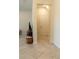 Well-lit hallway with tile flooring and a view of the staircase leading to upper levels at 11378 Whistling Pine Way, Orlando, FL 32832