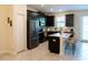 Stylish kitchen with sleek appliances, dark cabinets, and a functional center island at 11378 Whistling Pine Way, Orlando, FL 32832