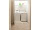 Well-equipped laundry room featuring a washer, dryer, and storage shelf for supplies at 11378 Whistling Pine Way, Orlando, FL 32832