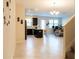 Open-concept living space with tile flooring and modern finishes that connects the kitchen to the living area at 11378 Whistling Pine Way, Orlando, FL 32832